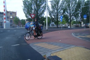 The Dutch have accomodated bicycling so well that a woman feels comfortable toting her three kids to school.